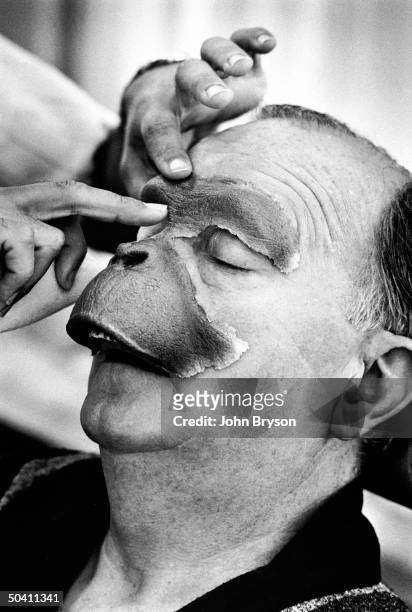 Foam-rubber make-up being applied to actor Maurice Evans face for his simian role in film Planet of the Apes.