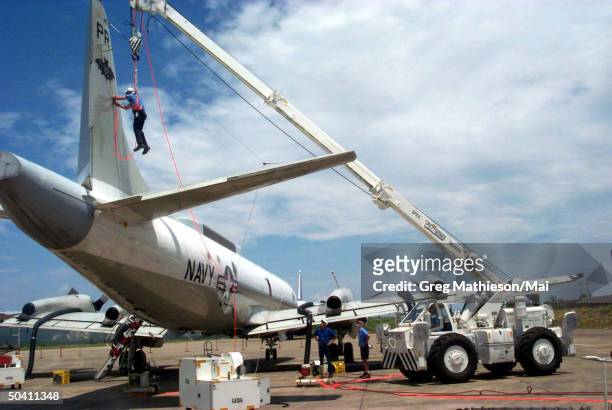 Lockheed Martin Aeronautics Co. Recovery team member preparing the U.S. Navy EP-3E Aries II dorsal fin for removal. The recovery team is performing...