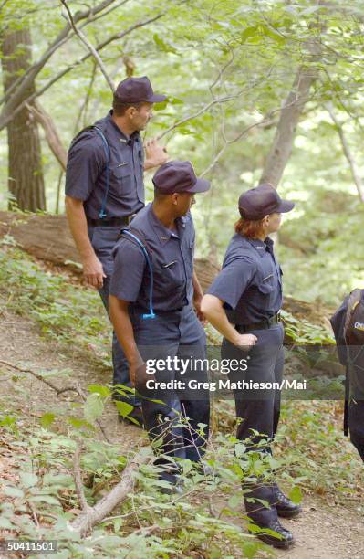 Police cadets searching the woods of Rock Creek Park for evidence following the disappearance of Washington intern Chandra Levy.