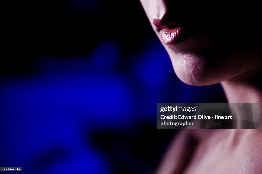 Mouth of young lady wearing lipstick