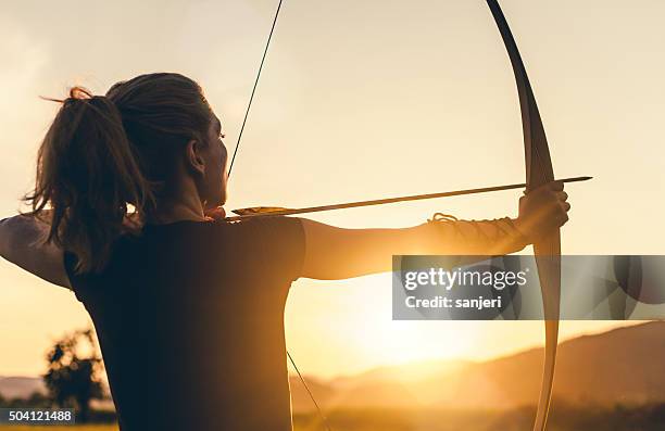 woman shooting with the longbow - arrows target stock pictures, royalty-free photos & images