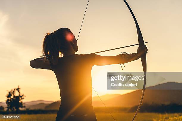 woman shooting with the longbow - archery target stock pictures, royalty-free photos & images