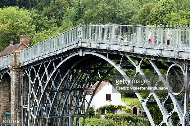 people walking on iron bridge in shropshire, england - telford stock pictures, royalty-free photos & images