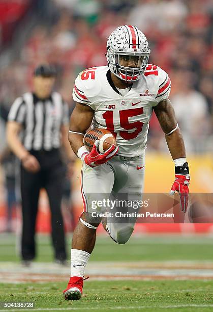 Running back Ezekiel Elliott of the Ohio State Buckeyes rushes the football during the first half of the BattleFrog Fiesta Bowl against the Notre...