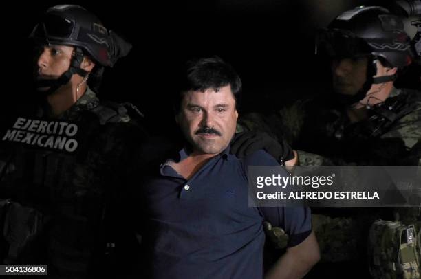 Drug kingpin Joaquin "El Chapo" Guzman is escorted into a helicopter at Mexico City's airport on January 8, 2016 following his recapture during an...
