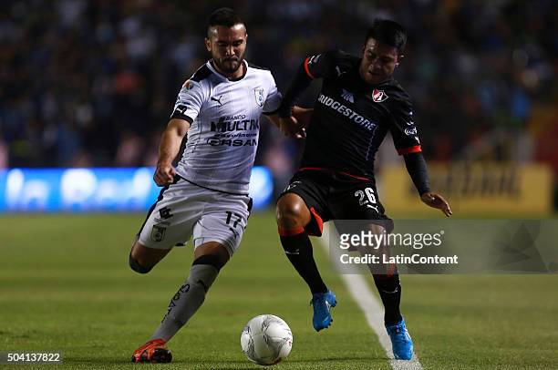 Mario Osuna of Queretaro struggles for the ball with Juan Carlos Medina of Atlas during the 1st round match between Queretaro and Atlas as part of...