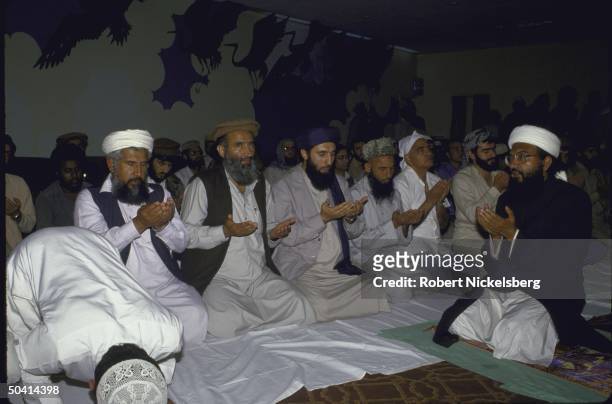 Afghan rebel group leader Gulbuddin Hekmatyar praying with other rebel leaders during Afghan Alliance meeting of various guerrila factions.