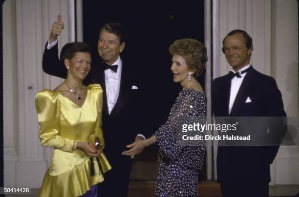 Pres. Ronald W. Reagan & wife Nancy welcoming King Carl Gustaf XVI of Sweden and his wife to White House for a State Dinner.