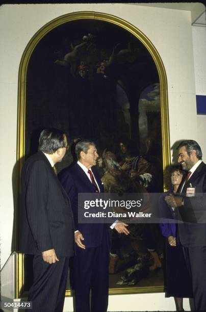 President Ronald W. Reagan talking with Italian Prime Minister Giovanni Goria and Italian Foreign Minister Giulio Andreotti during NATO meetings.