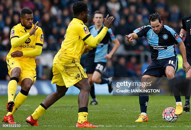 Wycombe Wanderers' Sam Wood vies with Aston Villas Micah Richards and Aston Villa's Dutch midfielder Leandro Bacuna during the FA Cup third round...