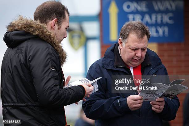 Fans read the offical programme prior to The Emirates FA Cup Third Round match between Leeds United and Rotherham United at Elland Road on January 9,...