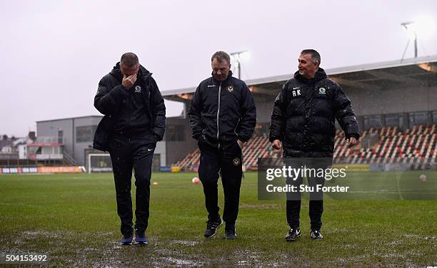 Newport manager John Sheridan discusses the possibilities of play on a waterlogged pitch with Blackburn manager Paul Lambert and coach Mike Kelly...