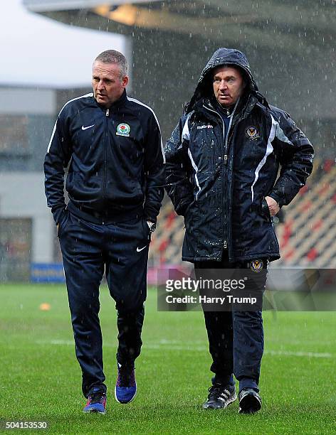 Blackburn Rovers Manager Paul Lambert and John Sheridan, Manager of Newport County chat as heavy rain forces the postponement of the match during The...