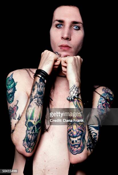 Rock singer Marilyn Manson aka Brian Warner displaying his tattoos.