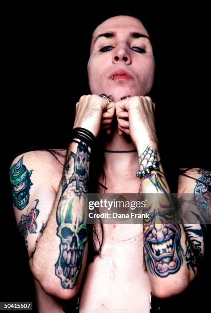 Rock singer Marilyn Manson aka Brian Warner displaying his tattoos.