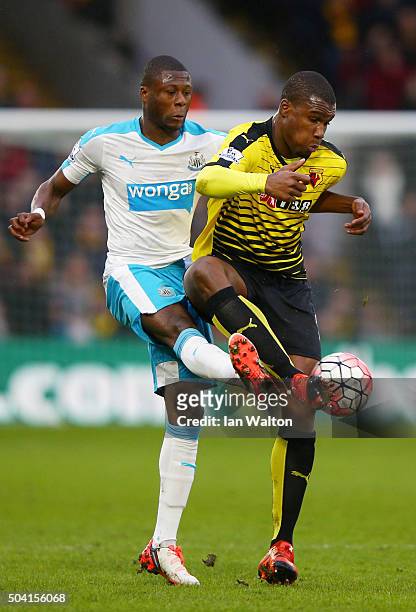 Obbi Oulare of Watford and Chancel Mbemba of Newcastle United compete for the ball during the Emirates FA Cup Third Round match between Watford and...