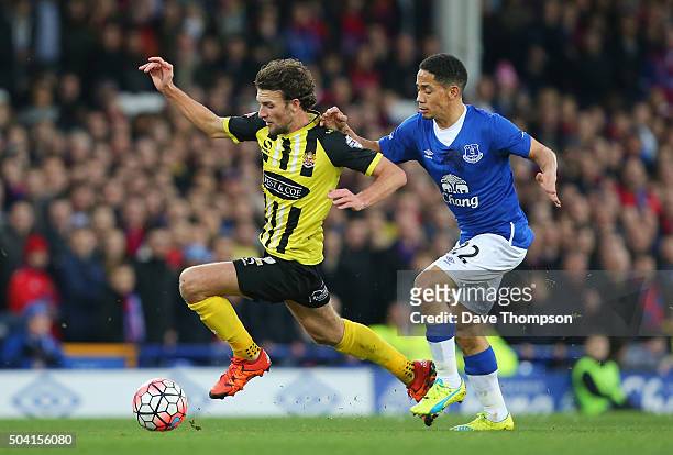 Christian Doidge of Dagenham and Redbridge and Steven Pienaar of Everton compete for the ball during the Emirates FA Cup third round match between...
