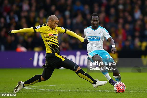 Cheik Ismael Tiote of Newcastle United battles with Adlene Guedioura of Watford during the Emirates FA Cup Third Round match between Watford and...