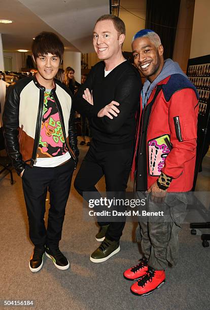 Kenji Wu, COACH Creative Director Stuart Vevers and Kid Cudi attend the Coach FW16 show front row during London Collections Men at The Lindley Hall...