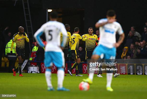 Troy Deeney of Watford celebrates scoring his team's first goal with his team mates while Newcastle United player react during the Emirates FA Cup...