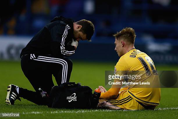Cauley Woodrow of Fulham receives treatment, before being substituted during The Emirates FA Cup Third Round match betwen Sheffield Wednesday and...