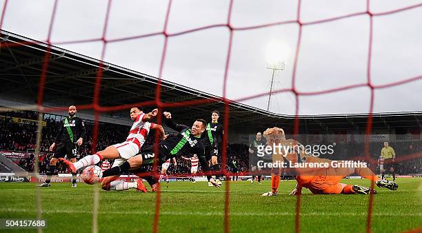 Nathan Tyson of Doncaster Rovers scores his team's first goal past Jakob Haugaard of Stoke City during the Emirates FA Cup Third Round match between...