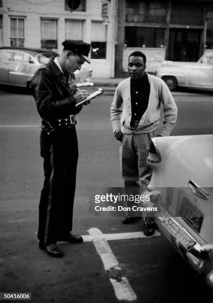 African American getting parking ticket, during bus boycott.
