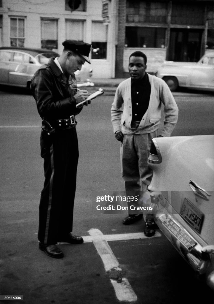 African American getting parking ticket