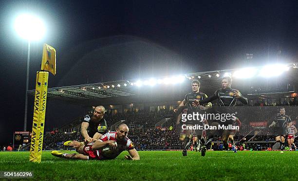 Charlie Sharples of Gloucester dives over for his side's first try under pressure from James Short of Exeter Chiefs during the Aviva Premiership...