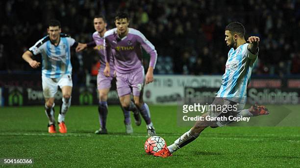 Nahki Wells of Huddersfield Town scores from the spot to level the game 2-2 during The Emirates FA Cup Third Round between Huddersfield Town and...