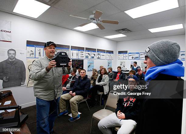 Gun instructor Mike Stilwell, , takes a picture of Bryce Dnovellis, as part of the Utah concealed gun carry permit class at Range Master of Utah, on...