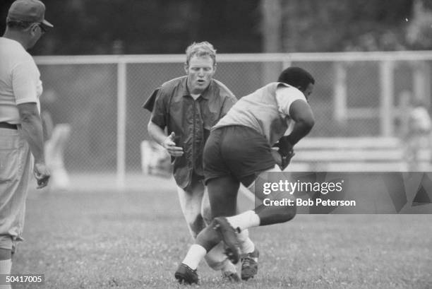 Redskins quarterback, Sonny Jurgensen and Coach, Vince Lombardi , during practice, at R. F. K. Memorial Stadium.