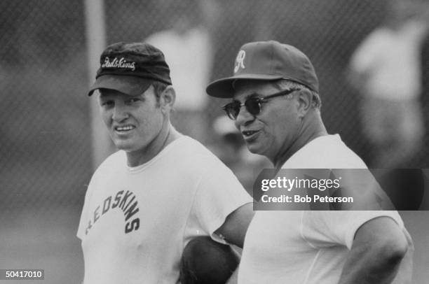 Redskins quarterback, Sonny Jurgensen and Coach, Vince Lombardi, talking during practice, at R. F. K. Memorial Stadium.