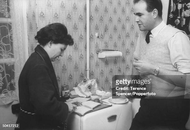 British Auto tool maker Ray Willis, who works at an Austin Motor Company plant in the West Midlands, making sandwiches with his wife at home in...