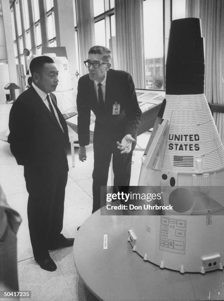 Defense Minister Ching Kuo Chiang, visiting the Manned Spacecraft Center, looking at Gemini Model being shown by Edward L. Hays.