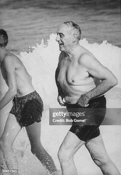 Robert Moses, head of the New York World's Fair, playing at the beach.