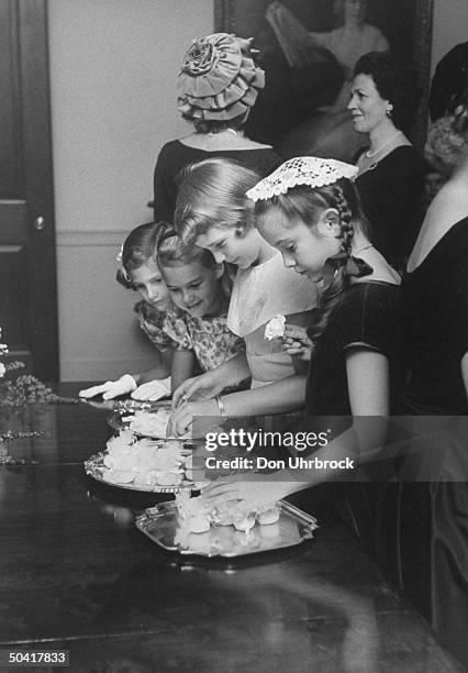 Ten year old daughter of Gov. LeRoy Collins of Florida, Darby Collins , arranging packets of rice to be thrown on the bridal couple.