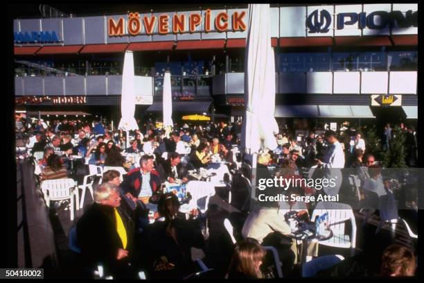 People sitting at outdoor cafe in Kurfursten Damn, in former West Berlin.