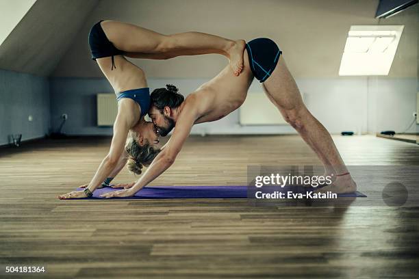 young people exercising yoga - hot yoga stock pictures, royalty-free photos & images