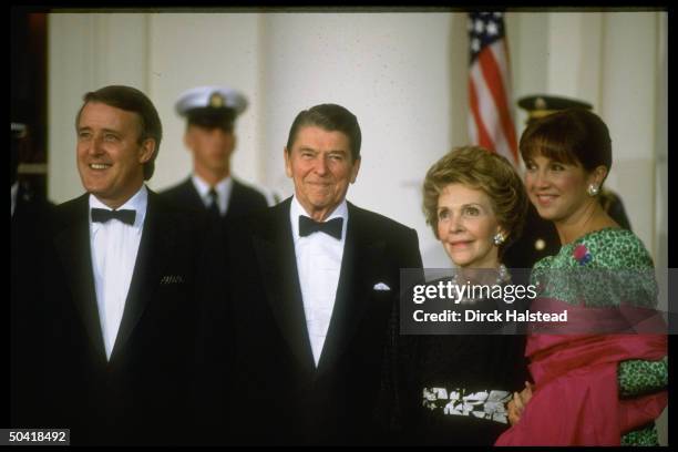 Pres. & Nancy Reagan w. Canadian PM Brian & Mila Mulroney, men in black tie & ladies in fancy gowns, during WH state dinner.