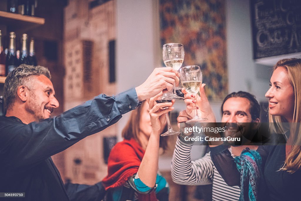 Group of Friends Toasting with Wine in a Wine Bar