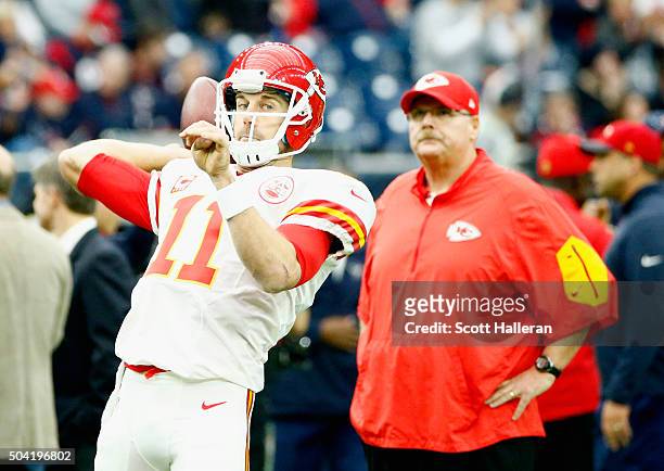 Quarterback Alex Smith of the Kansas City Chiefs looks to pass as head coach Andy Reid looks on before the AFC Wild Card Playoff game against the...