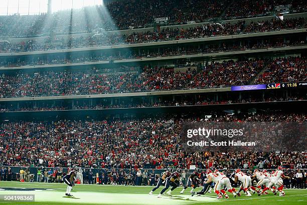 Quarterback Alex Smith of the Kansas City Chiefs drops back to pass against the Houston Texans during the first quarter of the AFC Wild Card Playoff...