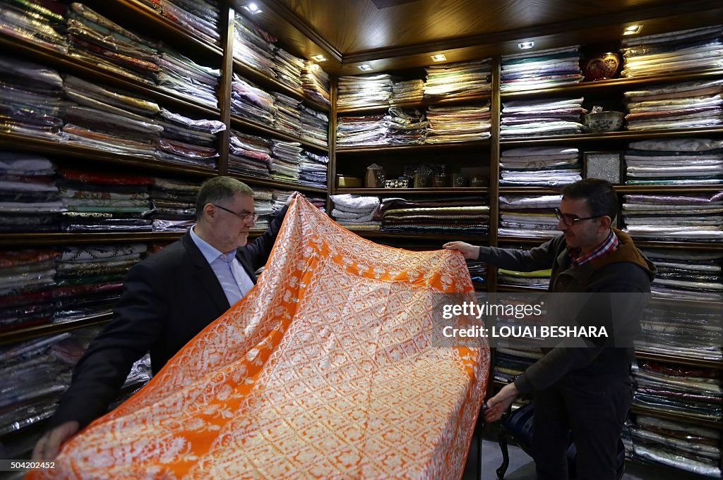 Syrian Rug Salesman Syrian shop-owner displays handmade silk at his shop in the Syrian ...