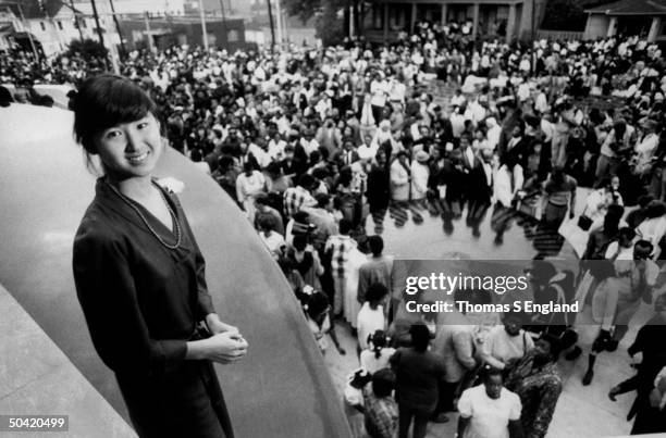Architect Maya Lin standing on balcony of building where her civil rights monument is being dedicated at the Southern Poverty Law Center where civil...