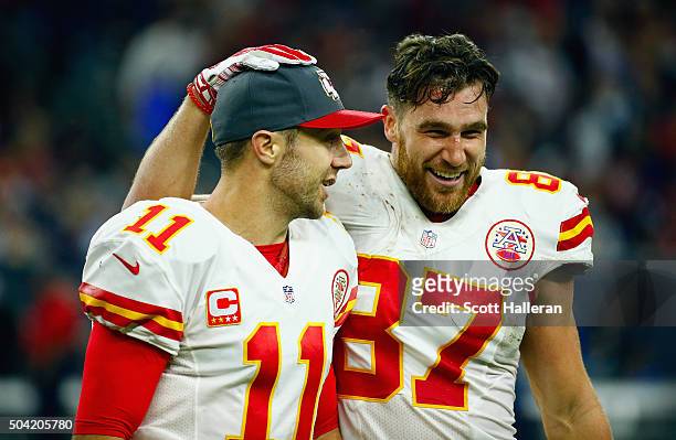 Travis Kelce and quarterback Alex Smith of the Kansas City Chiefs celebrate a fourth quarter touchdown by Spencer Ware during the AFC Wild Card...