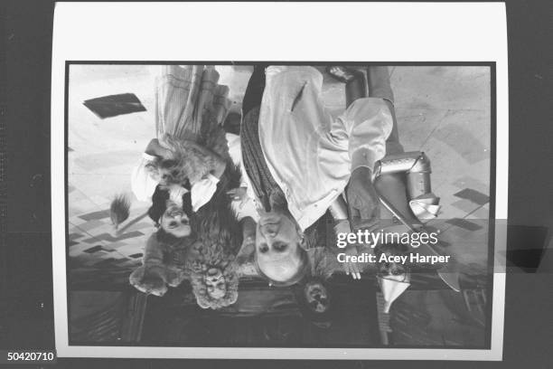 Portrait of the cast of the stage version of the Wizard of Oz surrounding producer Michel Grilikhes; Joe Giuffre as the Tin Man, Joe McDonough as the...
