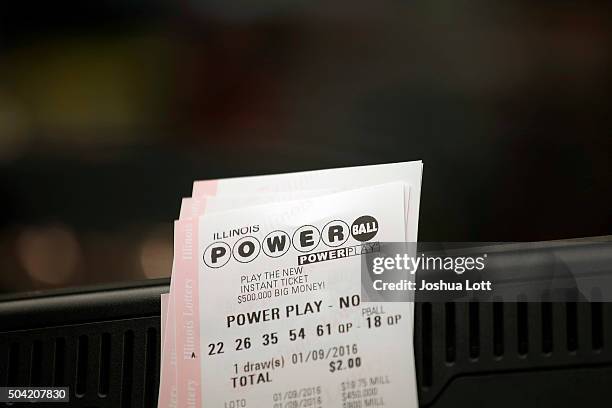 Powerball tickets rest on a 7-Eleven store register January 9, 2016 in Chicago, Illinois. The Powerball Jackpot Surged to a record $900 Million in 44...