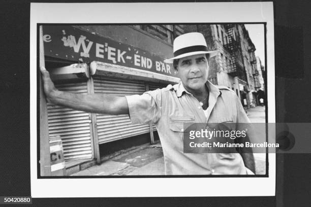 Supreme Court judge and author Edwin Torres posing in front of The Weekend Bar in Spanish Harlem.
