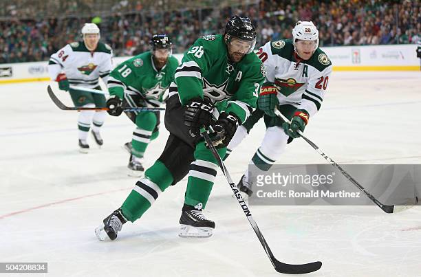 Vernon Fiddler of the Dallas Stars skates the puck past Ryan Suter of the Minnesota Wild in the first period at American Airlines Center on January...